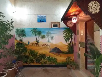 a mural on the wall of a building with a painting at Dar Berrada-Ziat in Fès