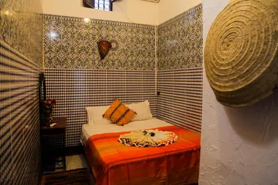a small room with a small bed in a room at Dar Berrada-Ziat in Fès