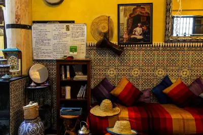 a room with a bed with colorful pillows on it at Dar Berrada-Ziat in Fès