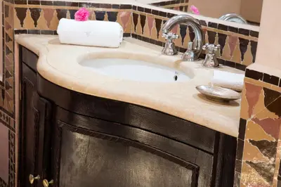 a bathroom sink with a granite counter top at Villa Jannah in Marrakech