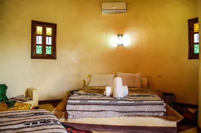 a bedroom with a large bed in a room at Skoura Lodge in Skoura