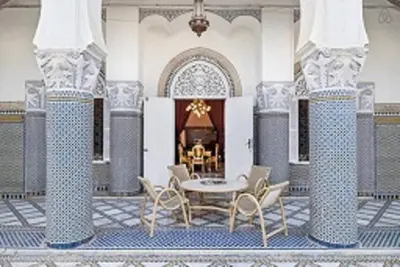 a patio with a table and chairs in a building at 2 BR Charming Apartment Fes in Fès
