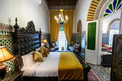 a bedroom with a bed and a chandelier at 2 BR Charming Apartment Fes in Fès