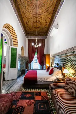 a bedroom with a bed and a couch in a room at 2 BR Charming Apartment Fes in Fès