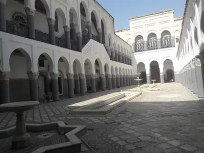 a courtyard of a building with a bench in front of it at 2 BR Charming Apartment Fes in Fès