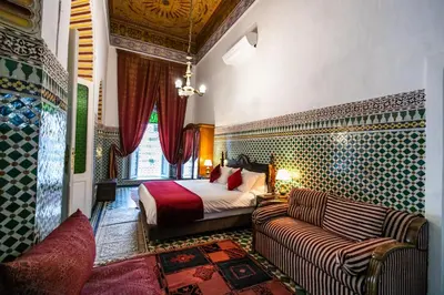 a bedroom with a bed and a couch in a room at 2 BR Charming Apartment Fes in Fès