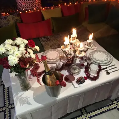 a white table with candles and flowers on it at Riad Amor - Suite & Spa in Fès