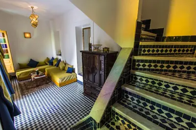 a living room with a staircase and a couch at Riad Amor - Suite & Spa in Fès