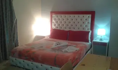 a bedroom with a bed with two towels on it at Hotel School Ersat Azrou in Azrou