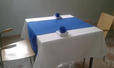 a white table with two blue vases on top of it at Hotel School Ersat Azrou in Azrou
