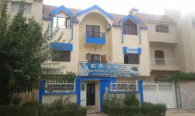 an apartment building with a sign that reads exit at Hotel School Ersat Azrou in Azrou