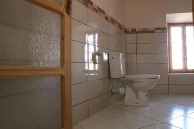 a bathroom with a toilet and a window at Riad Amodou in Tinerhir