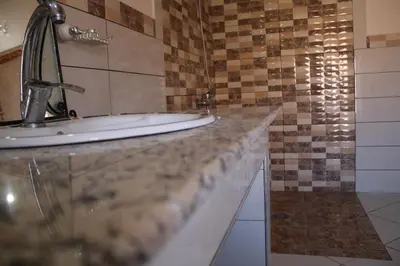 a bathroom with two sinks on a counter at Riad Amodou in Tinerhir