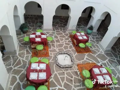 a rendering of a patio with tables and chairs at Riad Amodou in Tinerhir