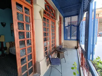 a room with a table and chairs on a balcony at youssef in Fès