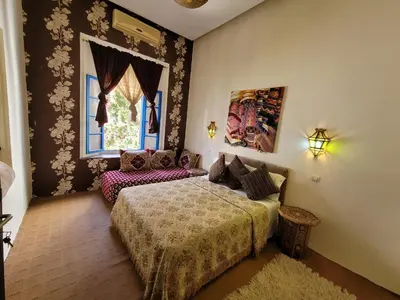 a bedroom with a bed and a window at youssef in Fès