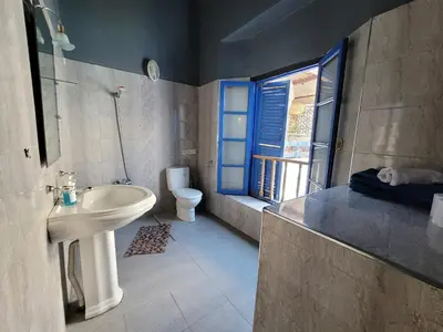 a bathroom with a sink and a toilet and a window at youssef in Fès