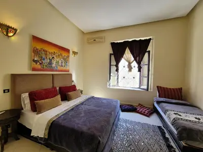 a bedroom with a large bed and a window at youssef in Fès