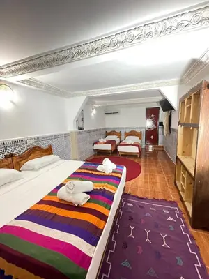 a hotel room with two beds with towels on them at La Casa Espanyola in Fès