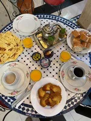 a table with plates of food on top of it at La Casa Espanyola in Fès