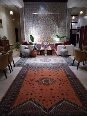 a room with a persian rug on the floor at Riad Passiflora in Fès