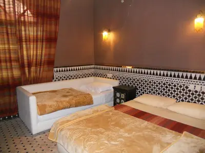 a room with two beds in a room at Riad Passiflora in Fès