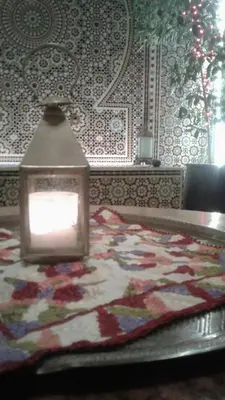 a room with a table with a rug on it at Riad Passiflora in Fès