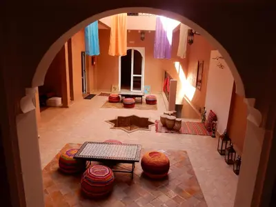 an archway in a room with a table and chairs at Riad Tazawa in Ibrahene