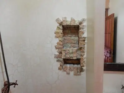 a wall with a stack of fire bricks at Riad Tazawa in Ibrahene