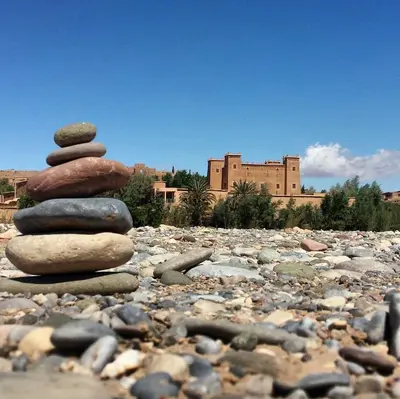 a stack of rocks sitting on top of a rocky field at Riad Tazawa in Ibrahene