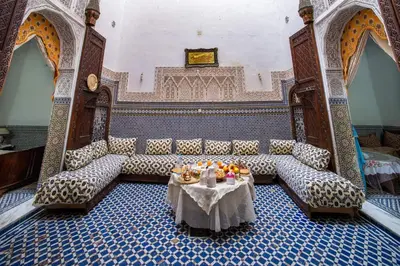 a room with a couch and a table with fruit on it at Dar El Arfaoui in Fès