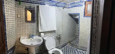 a bathroom with a toilet and a sink at Dar El Arfaoui in Fès