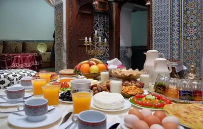 a breakfast table with food and drinks on it at Dar El Arfaoui in Fès