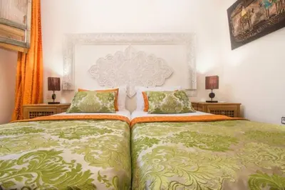 a bedroom with a large bed and two night stands at Riad Vega in Fès