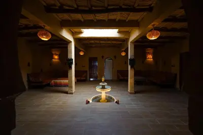 a large room with a table in the middle of it at Riad Marhaba Merzane in Merzane