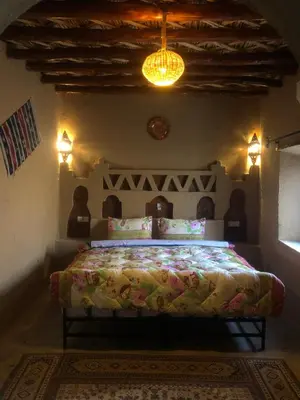 a bedroom with a bed in a room at Riad Marhaba Merzane in Merzane