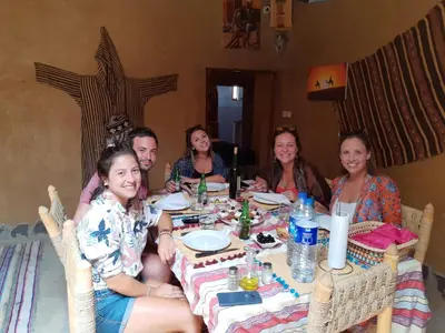 a group of people sitting around a table at Riad Marhaba Merzane in Merzane