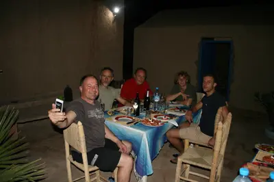 a group of people sitting around a table at Riad Marhaba Merzane in Merzane