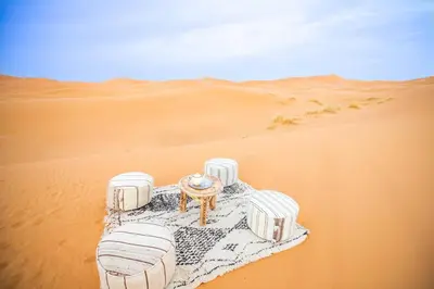 a table in the middle of a desert at Riad Kasbah Aiour in Merzouga