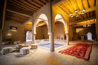 a large room with a swimming pool in a building at Riad Kasbah Aiour in Merzouga