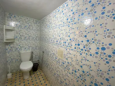 a bathroom with a toilet and blue and white tiles at Dar benelmahi in Fès