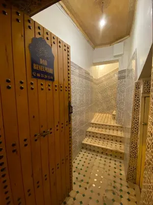 a bathroom with wooden lockers in a restroom at Dar benelmahi in Fès