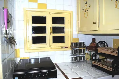 a kitchen with a stove and a window at Appartement Anatim in Ouarzazate