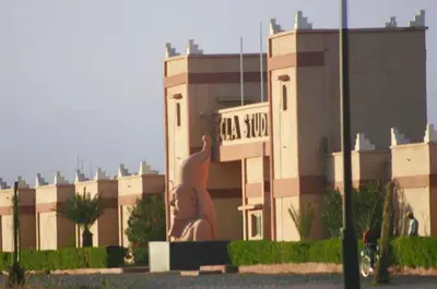 a building with a statue in front of it at Appartement Anatim in Ouarzazate