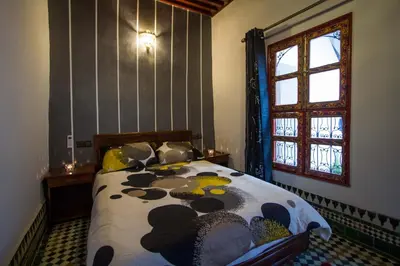 a bedroom with a bed and a window at Dar El Mathaf FES in Fès