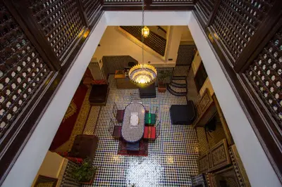 an overhead view of a room with a table on a tiled floor at Dar El Mathaf FES in Fès