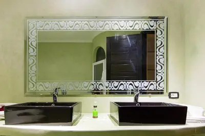 a bathroom with two sinks and a large mirror at Ksar Salha in Marrakech