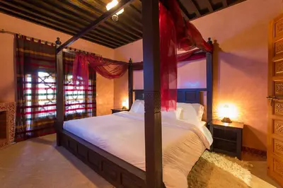 a bedroom with a canopy bed in a room at Ksar Salha in Marrakech
