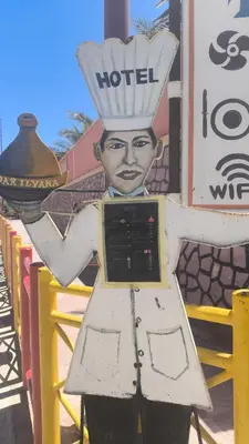 a statue of a man wearing a hotel sign at Dar Ilyana in Tamezmoute