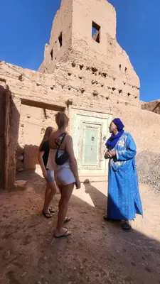 two women standing in front of a building at Dar Ilyana in Tamezmoute